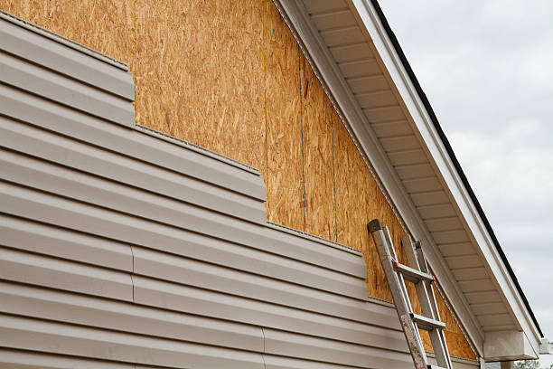 Professional Storm Damage Siding Repair technician working in West Elizabeth, PA
